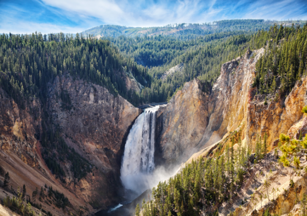 At Yellowstone National Park, a waterfall cascades into a deep canyon.